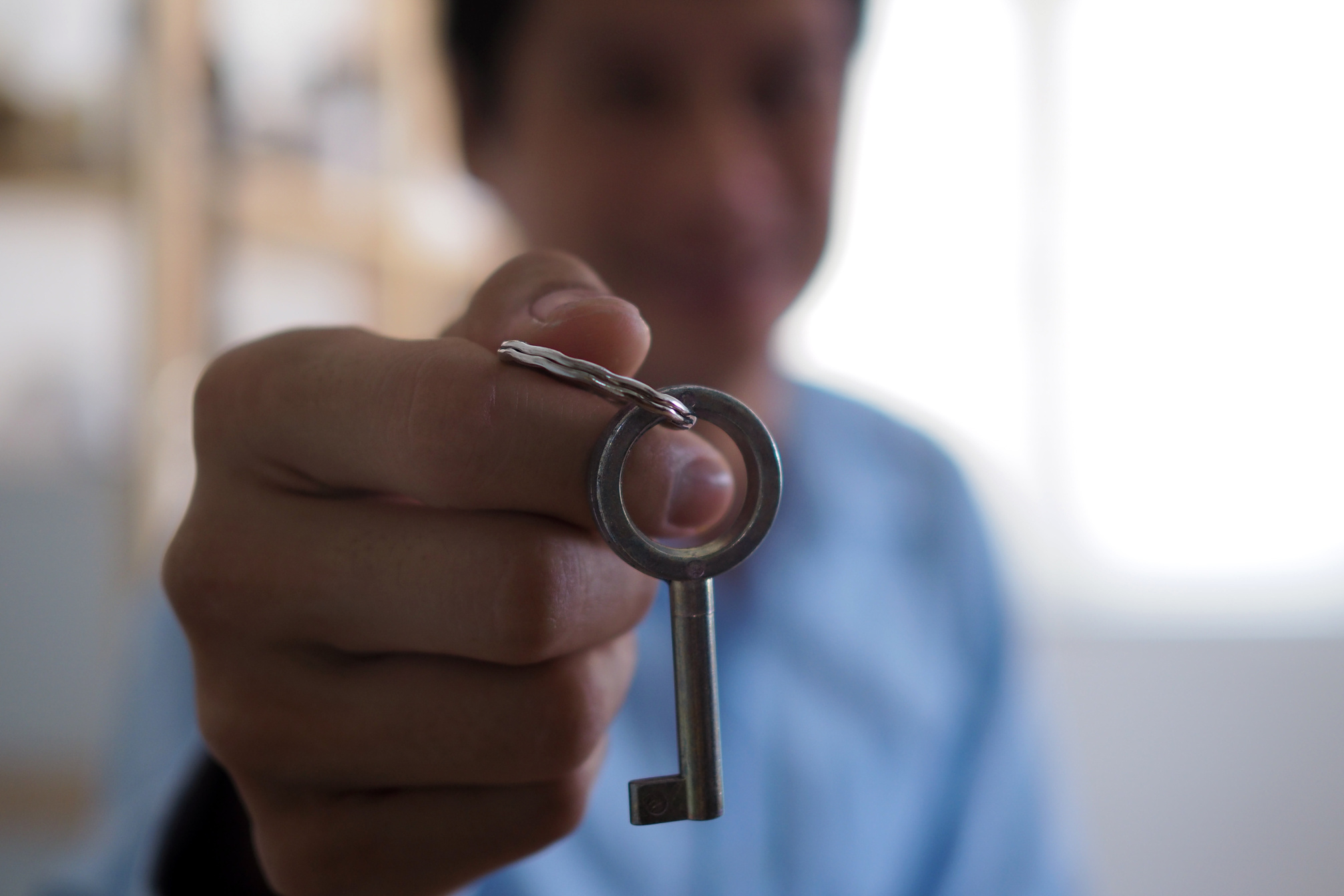 Man Handing House Key to Homebuyer